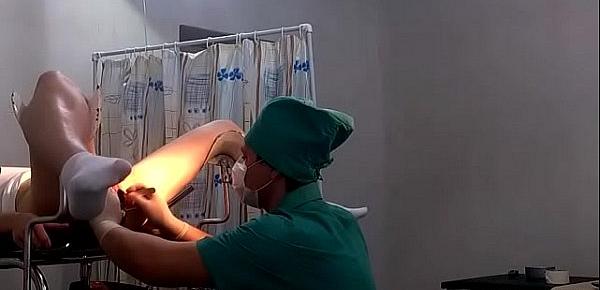  A girl in white socks on a gynecological chair